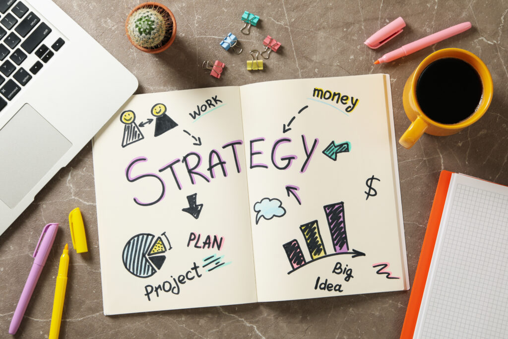 Creative workspace setup featuring a hand-drawn strategy plan illustrating the importance of thoughtful financial planning and strategy, including debt settlement, for managing money and achieving long-term goals.