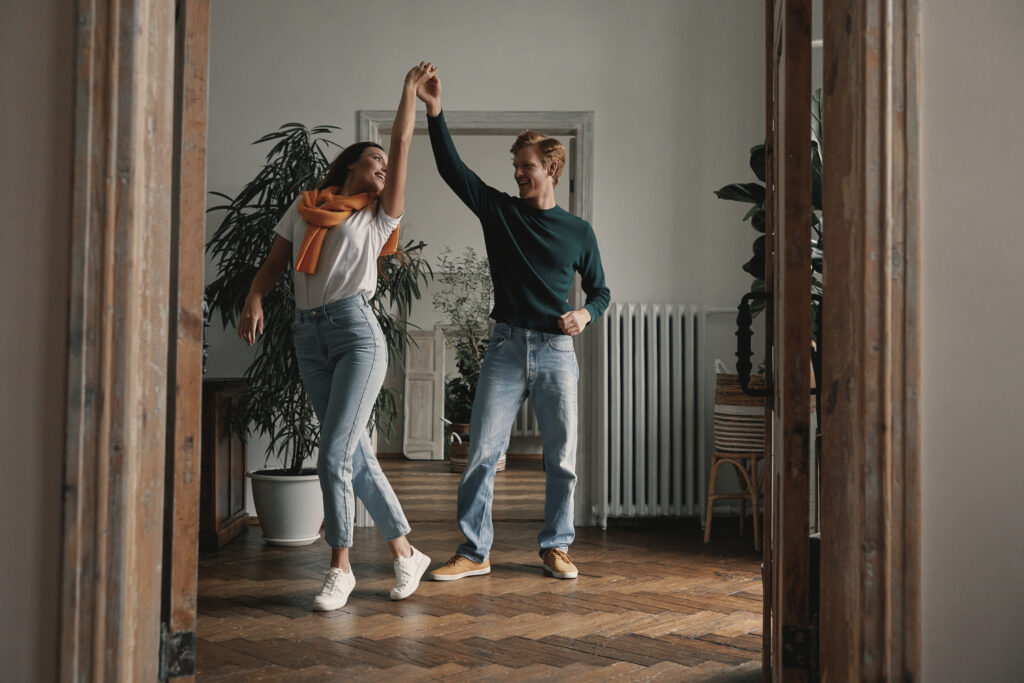 joyful couple dancing in their home, celebrating love, absolutely free