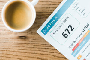mug of coffee and a personal credit report, suggesting a personal review of a credit report and credit score