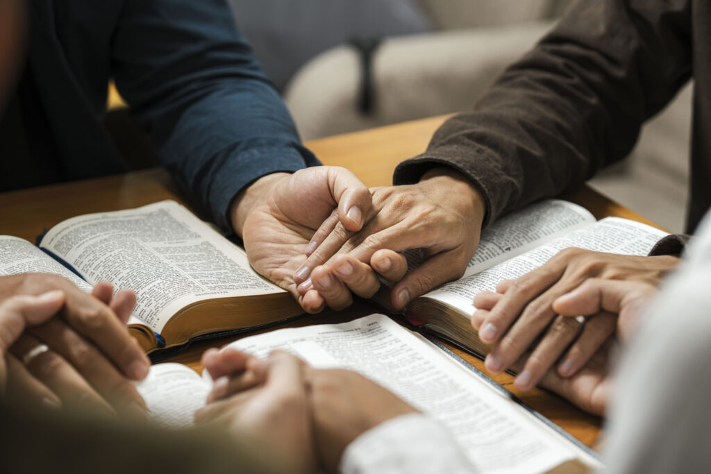 A group of young Christians working together to pray and seek blessings from God, the Bible, Christian ideas, sharing the gospel with each other.