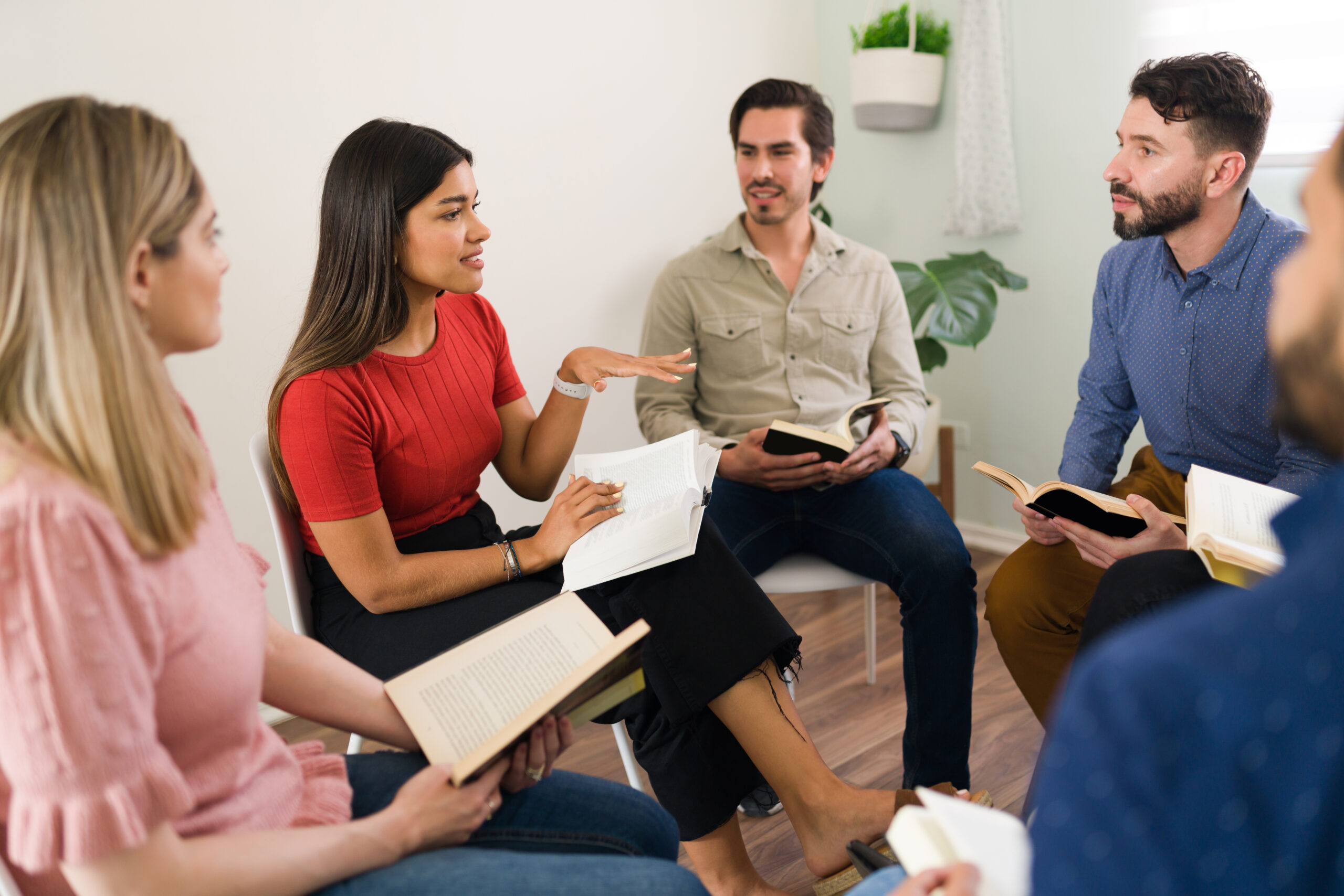 A small group of adults studying and discussing together in a welcoming setting